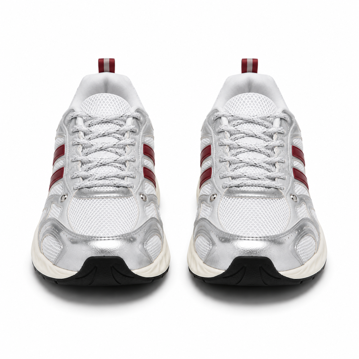 A pair of white and metallic silver running shoes with red side stripes and a black outsole, shown from a front-facing perspective on a white background.