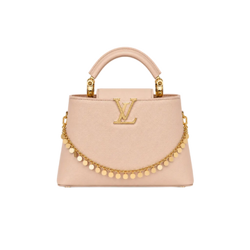 Louis Vuitton Capucines beige leather top handle handbag with gold LV logo, decorative gold chain charm, and structured silhouette.