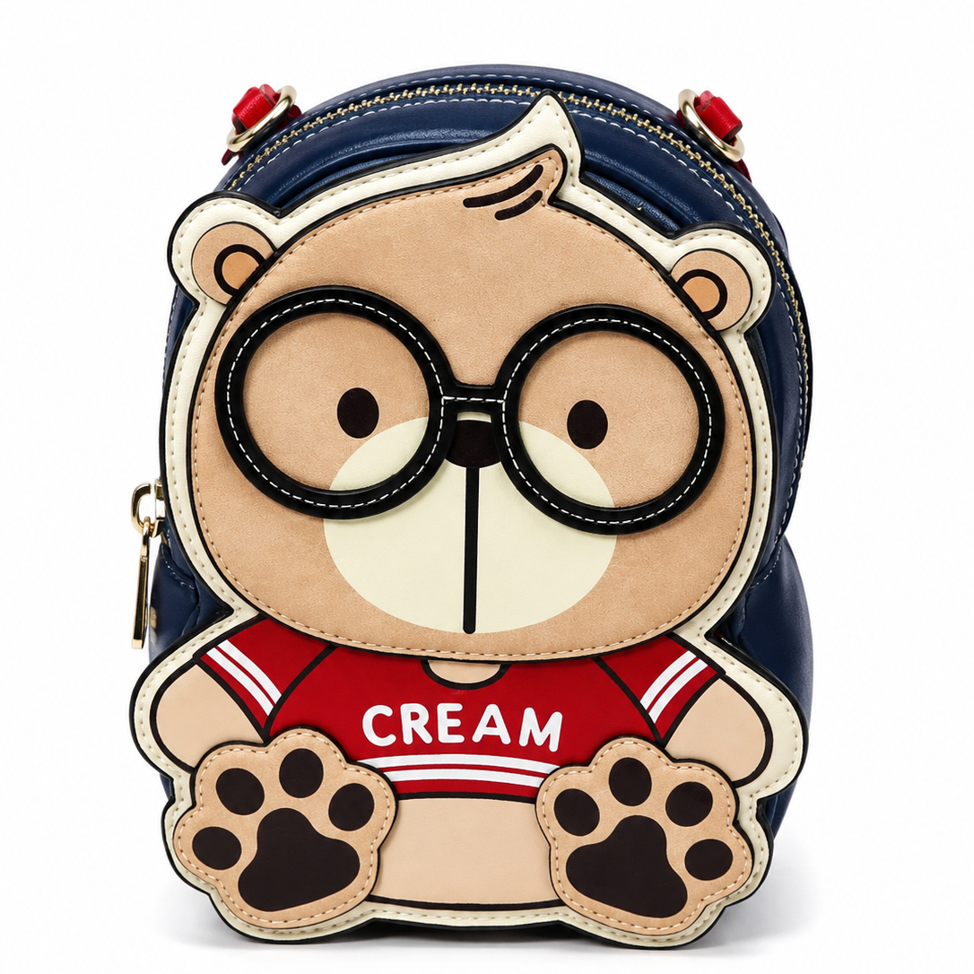 Navy blue cartoon bear kids crossbody bag with glasses, red "CREAM" shirt design, and white background.