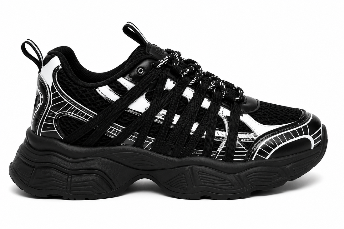 Women's chunky sneakers in black with white graphic overlays, breathable mesh upper, and thick cushioned sole.