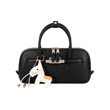 Black pebbled leather-look top handle handbag with silver hardware, dual zipper closure, and decorative horse charm on a white studio background.