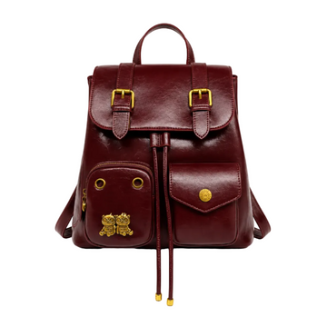 Burgundy vintage-style women's backpack with dual front pockets, buckle flap closure, top handle, and gold-tone hardware.