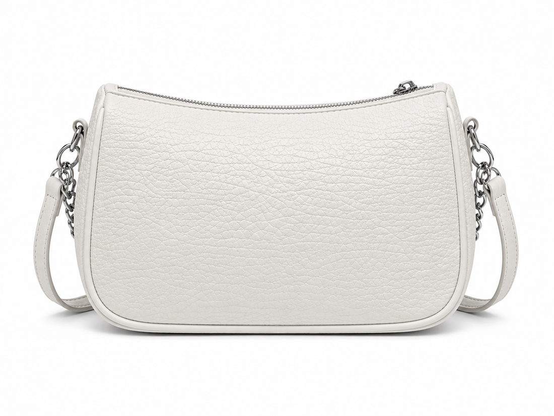 Front view of a white textured shoulder bag with silver chain accents and a curved silhouette, photographed in a professional studio on a clean white background.