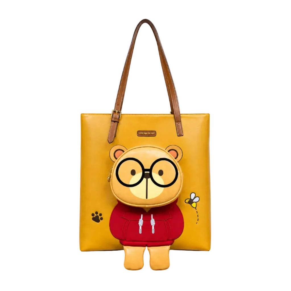 Mustard yellow women's tote bag with a large Cream Bear character pocket, long brown shoulder straps, and playful bee and paw print details.