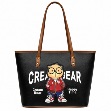 Black Cream Bear tote bag with brown shoulder straps, cartoon bear graphic, large Cream Bear logo, and white studio background.