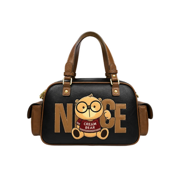 Black and brown Cream Bear Boston handbag with "NICE" lettering, cartoon bear graphic, dual top handles, and side pockets on a white studio background.