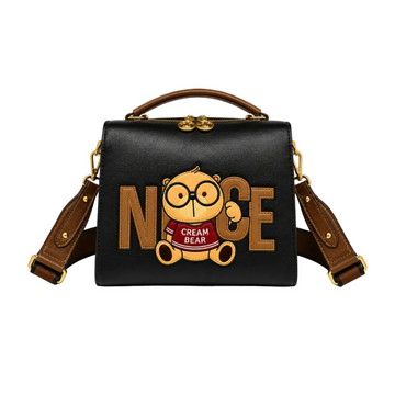 Black Cream Bear square crossbody bag with embroidered Cream Bear character, "NICE" lettering, top handle, adjustable shoulder strap, and gold-tone hardware.