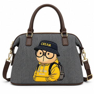 Grey Cream Bear satchel handbag featuring a yellow hoodie character embroidery, dual top handles, and a detachable shoulder strap.