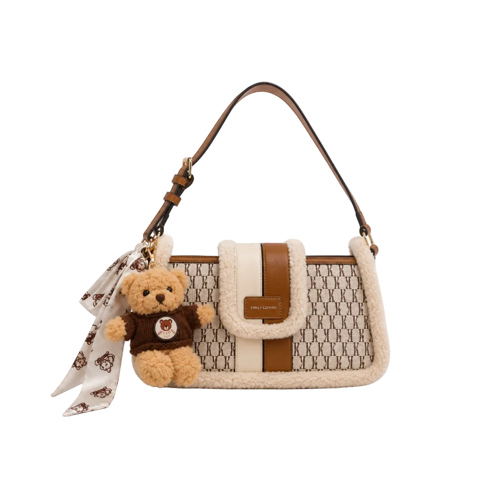 EMILY LORAN brown monogram shoulder bag with soft sherpa trim, adjustable shoulder strap, gold-tone hardware, and decorative teddy bear charm for everyday fashion.