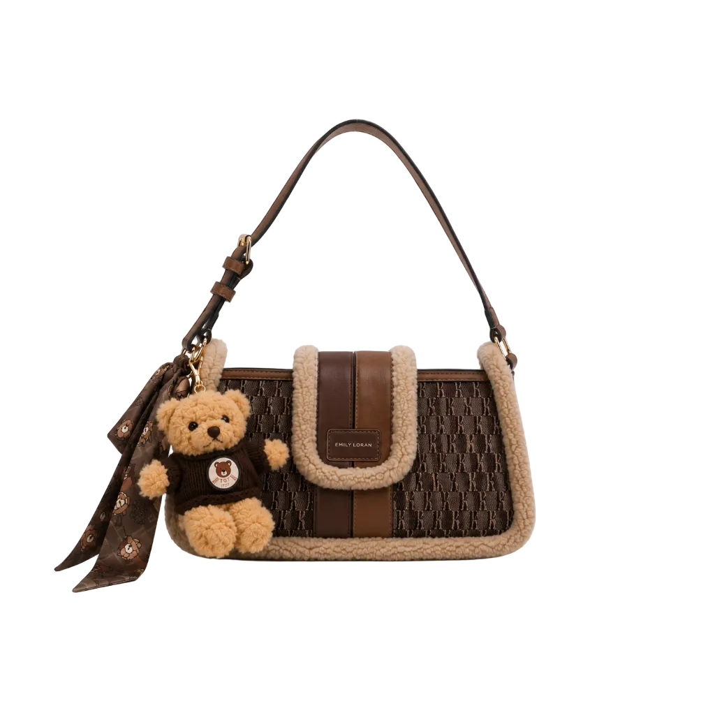 EMILY LORAN dark brown monogram shoulder bag with soft sherpa trim, adjustable shoulder strap, gold-tone hardware, and decorative teddy bear charm for everyday fashion.