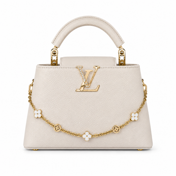 Louis Vuitton Capucines large cream leather handbag with pearl-detailed gold LV logo, floral gold charm chain, structured top handle, and elegant luxury designer styling.