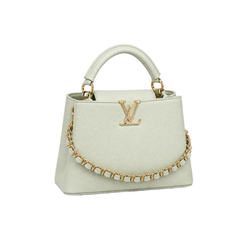 Louis Vuitton Capucines medium mint leather handbag with gold LV logo, decorative gold chain, structured top handle, and elegant luxury design.