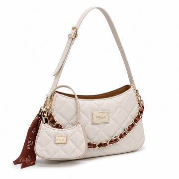 EMILY LORAN off white quilted shoulder bag with gold and tortoise chain, adjustable shoulder strap, matching mini pouch, and decorative ribbon.