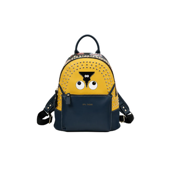 Yellow and navy backpack with cartoon eye design, silver-tone studs, front zip pocket, top handle, and adjustable shoulder straps on a white studio background.