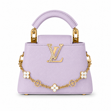 Louis Vuitton Capucines small lavender leather handbag with pearl-detailed gold LV logo, floral gold charm chain, structured top handle, and luxury designer styling.