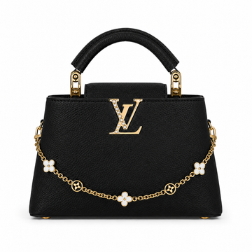 Louis Vuitton Capucines medium black leather handbag with pearl-detailed gold LV logo, floral gold charm chain, structured top handle, and luxury designer styling.