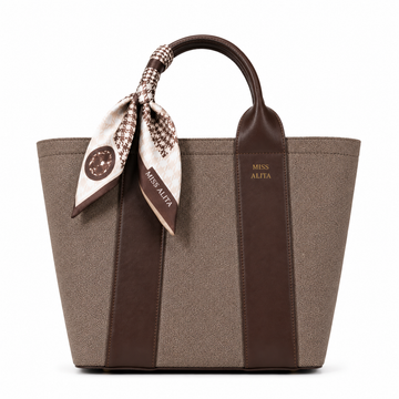 MISS ALITA dark brown canvas tote handbag with leather trim, decorative silk scarf handle, structured design, and gold logo on a white background.