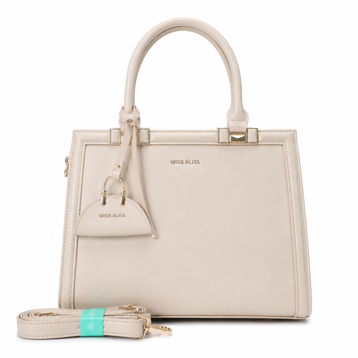 MISS ALITA beige structured top handle handbag with gold-tone hardware, detachable shoulder strap, and matching decorative charm on a white background.