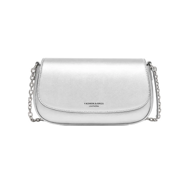 A silver metallic leather shoulder bag with a curved flap and a silver chain strap, featuring the text 'FASHION & BAGS LEATHERA' on the front, set against a plain white background.