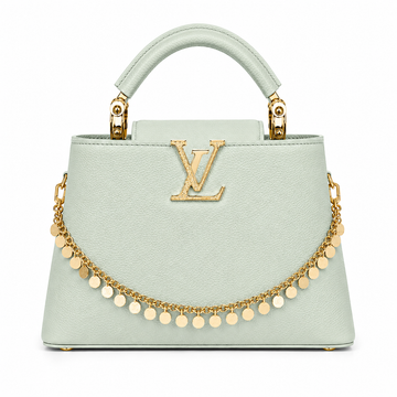 Louis Vuitton Capucines small mint leather handbag with gold LV logo, decorative gold charm chain, structured top handle, and elegant luxury designer style.