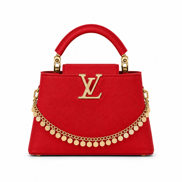 Louis Vuitton Capucines small red leather handbag with gold LV logo, decorative gold charm chain, structured top handle, and luxury designer styling.