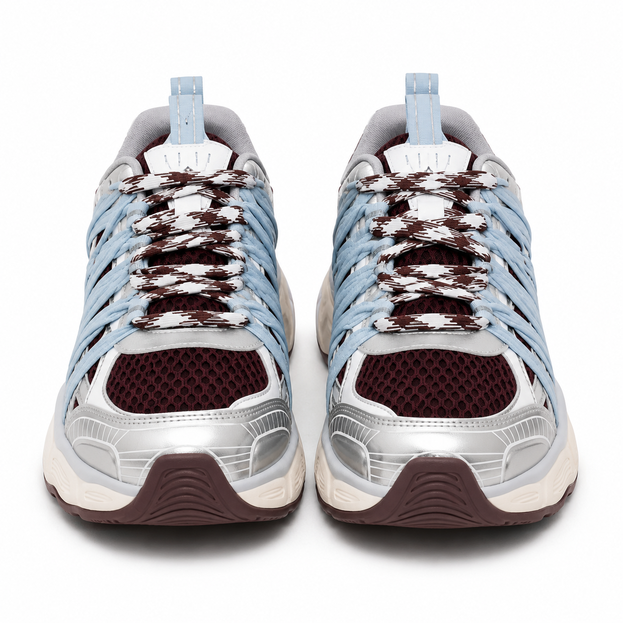 A pair of low-top athletic sneakers shown from the front on a white background. The shoes feature light blue synthetic overlays, a white mesh upper, dark brown knit laces, a metallic silver toe bumper, and a dark brown outsole.
