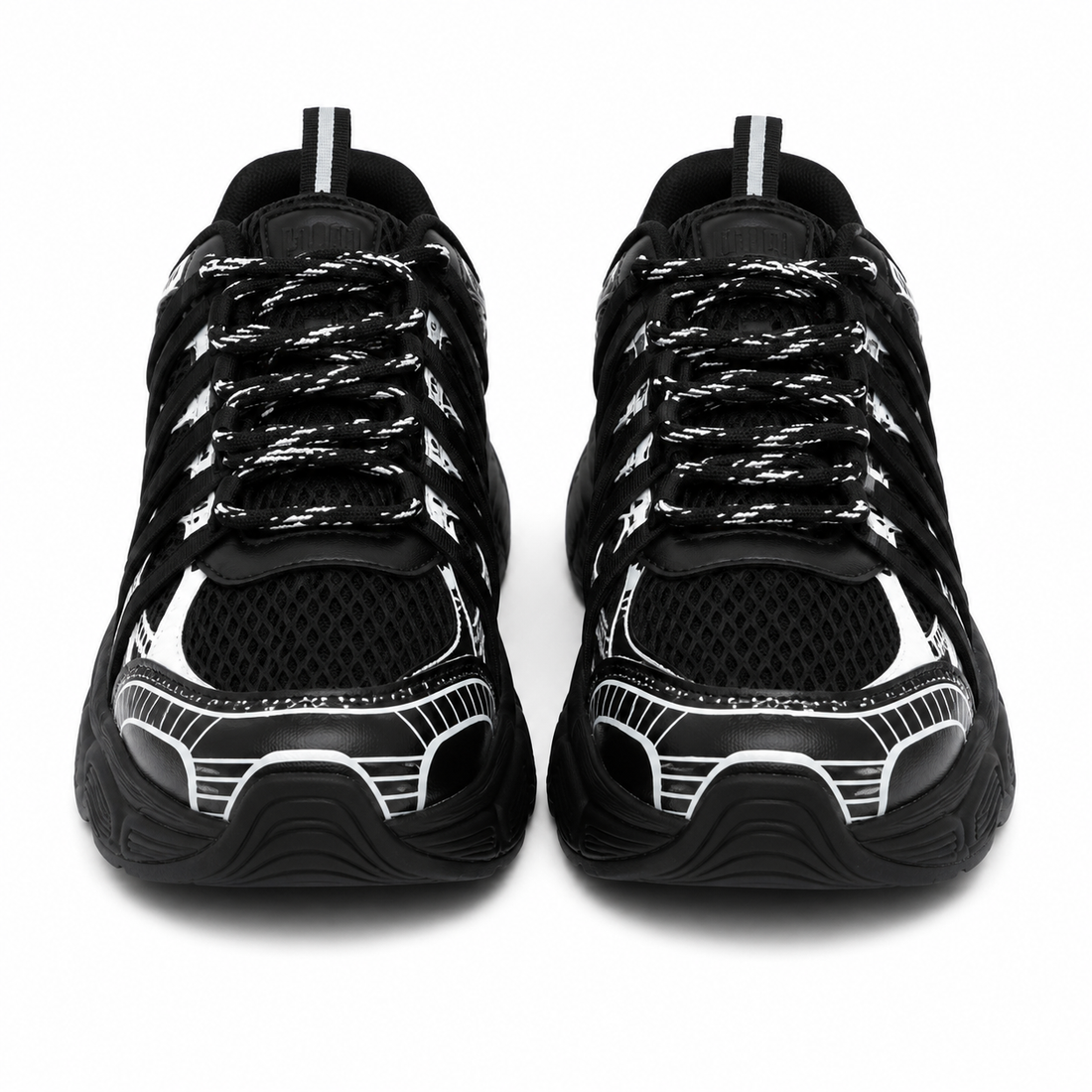 Women's chunky sneakers in black with white graphic overlays, breathable mesh upper, and thick cushioned sole.
