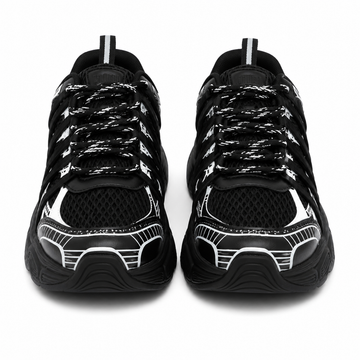 Women's chunky sneakers in black with white graphic overlays, breathable mesh upper, and thick cushioned sole.